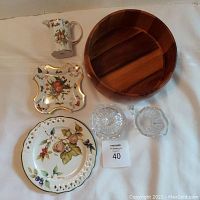Full view of all items displayed on white cloth: ceramic creamer, BonBon plate, lattice plate, wooden bowl, and leaded crystal creamer and sugar bowl.