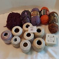 Full lot showing all skeins of yarn and crochet thread in front, with hand weaving cards stacked on right side