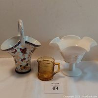 Front view of all three items: porcelain basket with butterflies on left, amber creamer center, white glass footed bowl right.