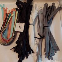 Image showing multiple nylon zippers in various colors including pastels and neutrals, bundled in groups