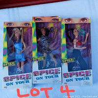 Front view of three 'Spice Girls On Tour' dolls in original boxes - Emma, Mel B, and Melanie C dolls in colorful packaging with windows showing dolls and accessories.