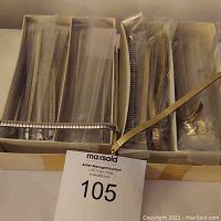Overview of 20 stretch watchbands in compartments with a MaxSold tag visible