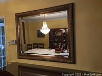 Full front view of mirror hung on wall showing overall appearance and size