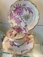Photo of Rosenthal Pompadour porcelain plate, tea cup, and saucer with purple floral pattern and gold trim.