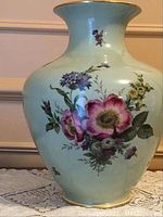 Front view of the light green Rosenthal porcelain vase with floral designs.