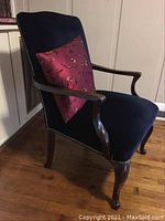 Front and side views of antique armchair with navy upholstery and purple decorative pillow, showing wooden cabriole legs and nailhead trim.