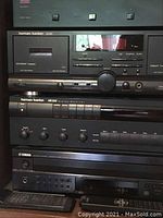 Adcom speaker selector switch atop stereo stack