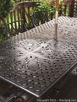 Close-up of table’s decorative lattice and floral pattern surface
