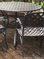 Close-up of table top lattice pattern and adjacent chair frame