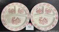 Top view of two vintage hallmarked Asian inspired triple section dinner plates showing dark red pastoral and architectural designs with pink floral border on cream background.