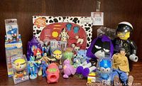 Wide view of the toy lot showing 101 Dalmatians playset, plush dolls including Raven, soft character doll, PEZ dispensers, and assorted figurines.