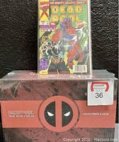 Deadpool comic book #7 circa 1997 in plastic sleeve placed on top of sealed red and black Lootcrate Marvel Deadpool: Merc with a Mouth collectible box
