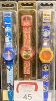 Front view of all three Disney collectible watches sealed in original packaging showing Cinderella, Pocahontas, Aristocats designs.
