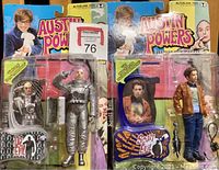 Photo of both Dr Evil and Scott Evil figures in sealed blister packaging, showing detailed accessories and branding.