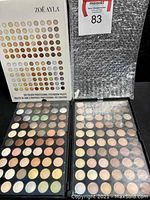 Closed and open views of the Zoe Ayla original box and 120 color eyeshadow palette in protective bubble wrap.