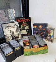 Two boxes filled with stacks of Magic The Gathering playing cards, showing assortment of cards in good condition.