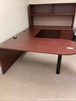 Wide view of modular desk against wall showing pedestal section, connector, and drawer/shelf section with hutch.