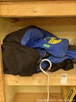 Photo of rolled up SeaDoo water tube on wooden shelf showing partial logo and rope.