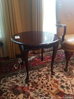 Front view of the solid mahogany round side table showing the polished cherry finish and tabletop.