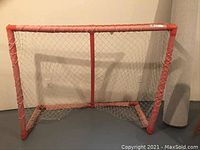 Full view of the ball hockey net with orange frame and white netting.
