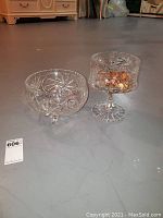 Two clear crystal bowls displayed on floor, showing contents and patterns