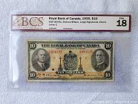 Front side of 1935 Royal Bank of Canada $10 note showing portraits, coat of arms, denomination, serial numbers, and BCS grading label Fine 18.