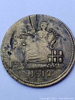 Obverse side showing seated figure holding scales and the date 1812 below.