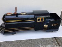 Side profile view of entire locomotive and tender showing black and gold finish