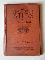 Cover of the 1921 edition atlas book The New World Atlas and Gazetteer with visible wear on spine and edges