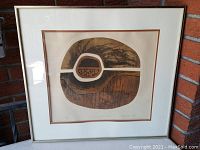 The framed mixed media artist proof shows the central abstract design with a layered texture and detailed interior pattern. The signature and edition numbering are visible under the image.