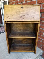 Front view of the oak desk topper with closed drop-down front and visible lock