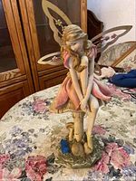 Front view of the bisque nymph angel sculpture showing detail of face, dress, and wings.