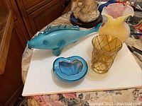 Blue Venetian style glass fish, blue Murano glass dish, and two Murano glass vases on a table