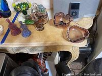 Photo showing Murano glass candy dishes and two small Murano glass bells on a table surface.
