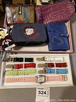 Photo of Betty Boop wallet with tags, variety of Fossil wallets, Invicta watches with extra interchangeable bands.