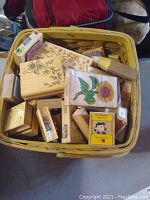 Basket full of various wooden craft stamps with florals and more motifs visible
