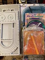Photo showing two white bead design boards and assorted crafting tools and accessories including Curvy Cutter and Circle Scissors