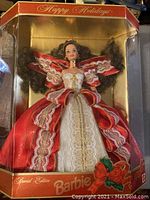 Close-up photo of Special Edition Happy Holidays Barbie doll in original box, showing dress and packaging details