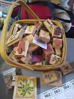Photo of basket full of craft stamps including various designs such as Disney characters and floral patterns.
