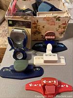 Craft punches arranged on flat surface with box