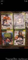 Photo showing the front covers of 4 Xbox games including NHL 2004, NHL 2002, Championship Poker, and NCAA Football 2003.