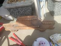 Photo of a solid wood spoon rack holder showing its size and condition outdoors.