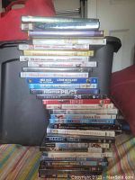 Photos show a stack of DVD cases including movie titles Ice Age, Bride Wars, Magic Mike, Fighter Pilot, Marley & Me, Hitch, Shrek, Adam & Eve, 50 First Dates, Predators, 12 Dogs of Christmas, Twilight, High School Musical 2, Spider-Man, and more.