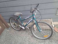 Full side view of green Sportek Hurricane bike showing frame, tires, pedals and saddle.