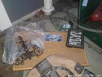 Wooden lap tray with blue and white ceramic tile designs, metal horse-drawn carriage style wine rack, and small decorative wooden frame