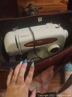 Top view of Brother sewing machine inside burgundy carrying case