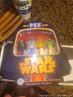 Photo of unopened Star Wars limited edition PEZ dispenser tin with four characters visible inside.