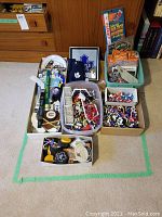 Overall lot showing bins and boxes containing mini sticks, figurines, nets, pucks, framed decor