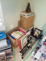 View of the boxed music books, recorders, and metronome on top of the box.
