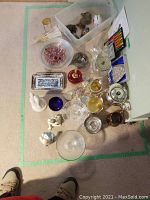 Overview of mixed decorative items including silver plated trays, plates, glass jar, mini mirror, piggy bank, turtles, glass bowl, pink beads dish, small candlestick holder, and figurines